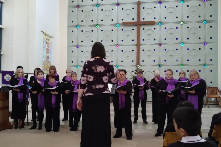 Songbirds choir stood performing together