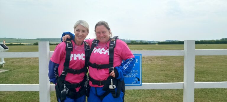 Claire and Sam smiling ready to get in the plane to start the skydive