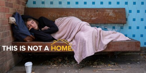 Young person facing homelessness sleeping on a bench. 