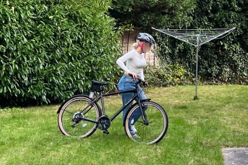 Young resident with their new bike in the garden after the bikes were awarded