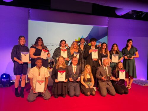 The Youth Matters Awards young finalists all stood on stage together holding their certificates and awards