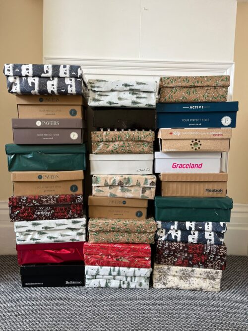 The boxes that Millie donated, all wrapped up in Christmas wrapping paper. Each is filled with essentials and treats for our residents this Christmas