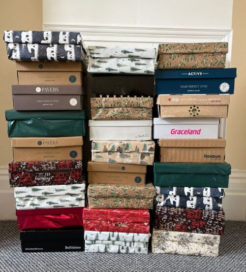 The boxes that Millie donated, all wrapped up in Christmas wrapping paper. Each is filled with essentials and treats for our residents this Christmas