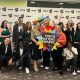 Youth Matters Awards 2023 finalists and staff at the event, holding a big sign that reads 'Youth Matters Awards'