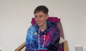 Vivian smiling, wearing a space patterned hoodie