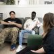 World Mental health and world homeless day image: two young people sat on a sofa smiling