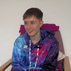 Vivian smiling, wearing a space patterned hoodie